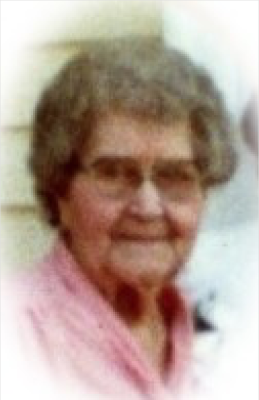 An older woman wearing a pink shirt.