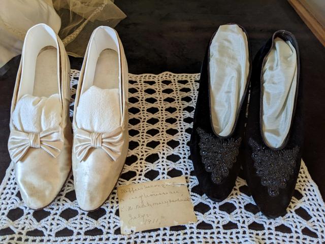 Wedding slippers and trousseau shoes at the Lucy Maud Montgomery Birthplace with Montgomery’s handwritten note that says, “Slippers belonging to my trousseau. L.M. Montgomery Macdonald. July 5 1911.”