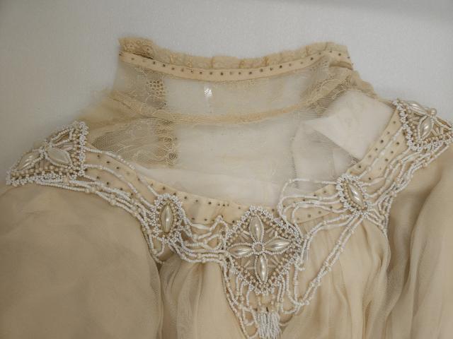 Montgomery’s original gown’s bodice showing steel-cut, iridescent ivory, and white beading, archived at the Confederation Centre of the Arts, Charlottetown, PEI.