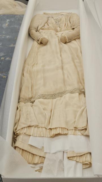 Montgomery’s ivory silk and lace Edwardian wedding gown with iridescent beading on the bodice, sleeves, and hem, and pleated taffeta underskirt.