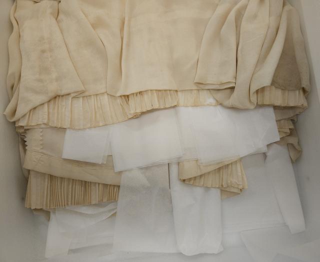 Machine-stitched silk of the original wedding gown’s overskirt and inside pleats showing shattering of the ivory-coloured taffeta.